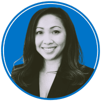 The image shows a smiling woman with long dark hair wearing a black jacket against a blue background.