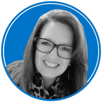 The image shows a smiling woman with long hair wearing glasses and a patterned top against a bright blue background.