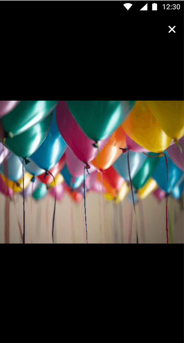 Colorful balloons float against a dark background, creating a vibrant and festive atmosphere.
